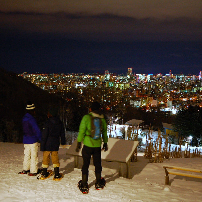 Snowshoe trekking in night snow forest / Sapporo