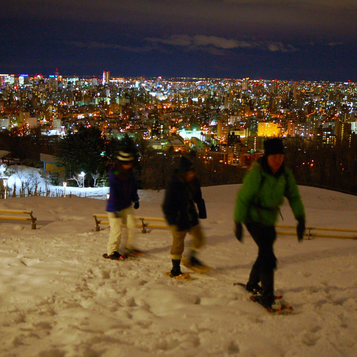 Snowshoe trekking in night snow forest / Sapporo